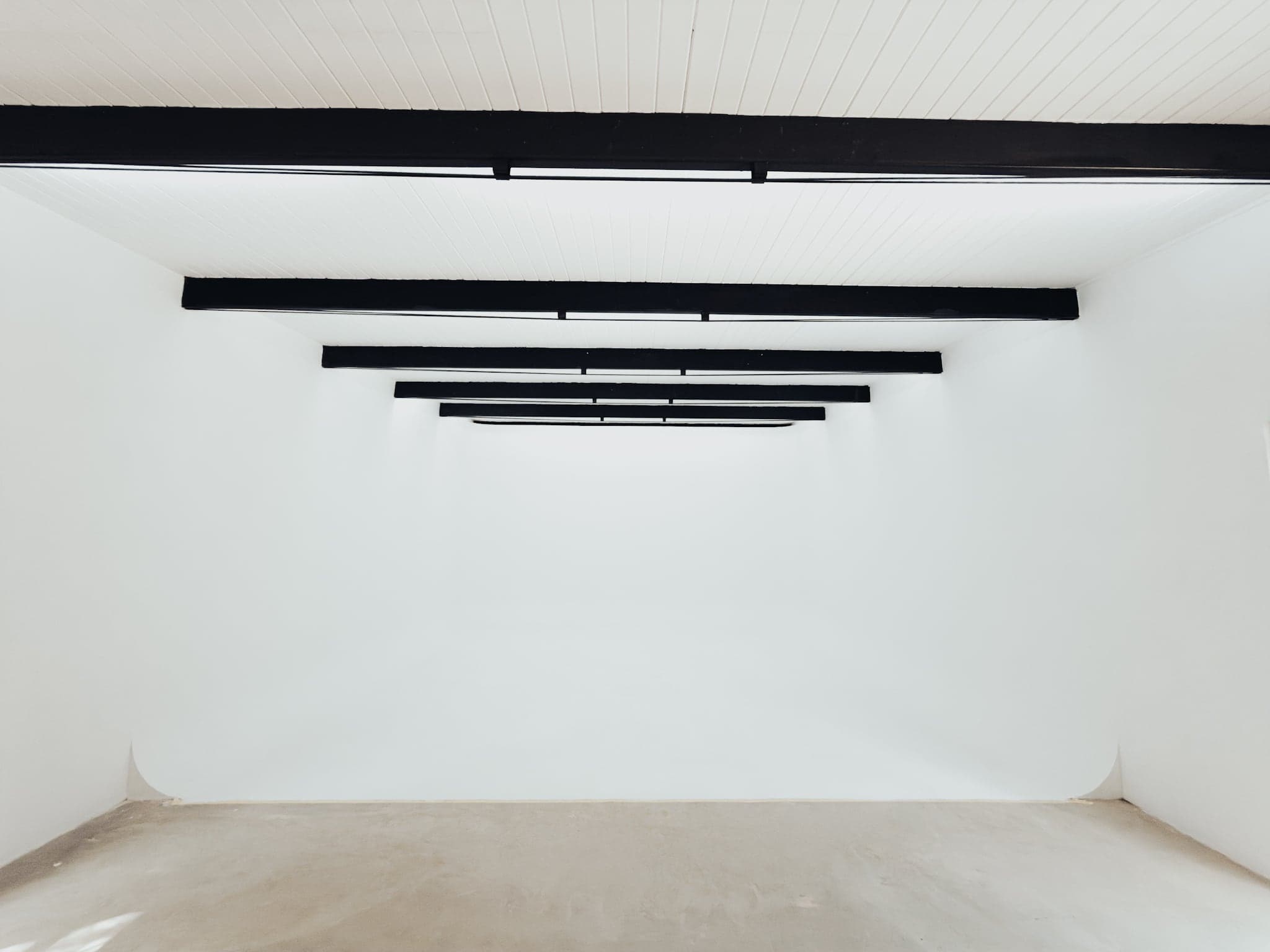 The empty white infinity curve under black track lights
